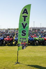 ATVs For Sale feather flag on grass with ATVs