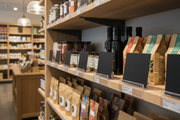 Black chalkboard shelf signs in a specialty retail store