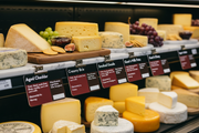 Cheese informational signs in a supermarket cheese counter