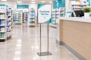Chrome 14 × 22 sign holder inside a drug store