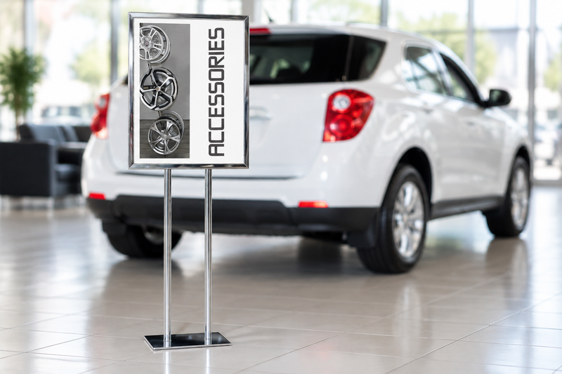 Chrome Iron Man sign holder in a dealership showroom