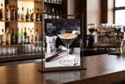 Flip-ring countertop sign stand in a restaurant bar setting