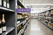 Aisle marker L-shaped magnetic sign holder displayed in flag position on retail store gondola shelving – lifestyle view