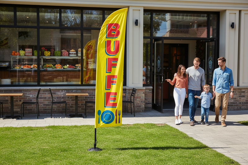 Buffet feather flag installed in green grass outside a restaurant entrance with diners, showing the outdoor food-service advertising use