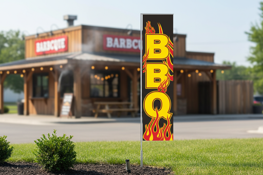 BBQ banner flag kit with original BBQ flame artwork, 12 foot by 3 foot flag planted in landscaped grass outside a BBQ restaurant