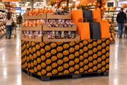Pumpkin Corrugated Base Pallet Wrap, 42 in x 25 ft, jack-o-lantern print wrapping a supermarket pallet display of Halloween candy and treat bags