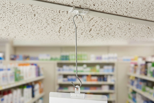 Galvanized steel double C-hook suspending a retail sign from a ceiling-grid attachment in a drug store.