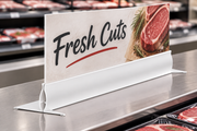 24-inch white sign foot holder supporting an illustrative Fresh Cuts sign in a supermarket meat department; sign sold separately