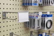 Clear PVC 2 x 1.25 inch label holder fitted over a metal pegboard scan plate in a retail display
