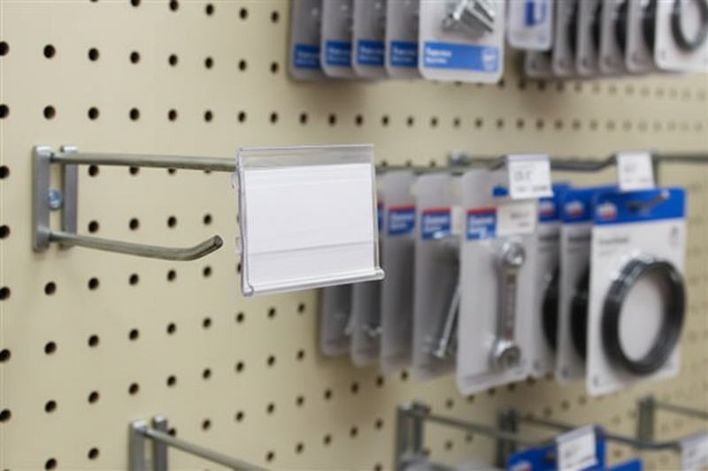 Clear PVC 2 x 1.25 inch label holder fitted over a metal pegboard scan plate in a retail display