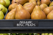 Chalk Decor organic Bosc pears name insert in a one-track produce display beside fresh pears