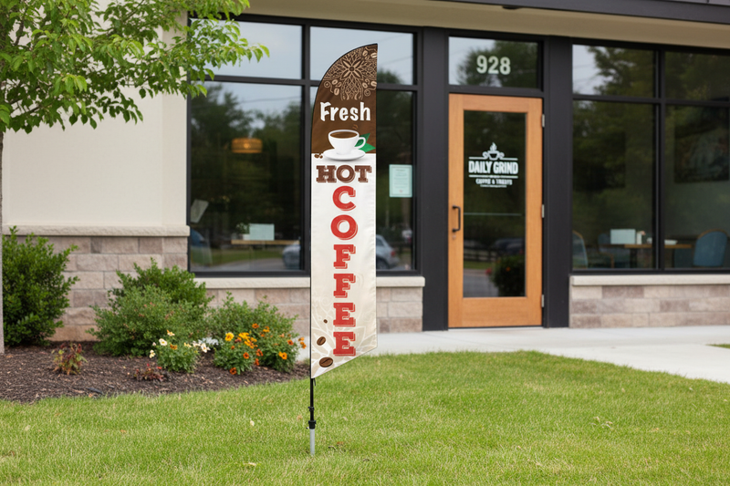 Fresh Hot Coffee feather flag planted in landscaped grass outside a retail storefront, 11.5'H x 2.5'W outdoor promotional sign with aluminum pole and ground spike
