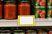 Horizontal 7 by 5.5 inch yellow starburst coated cardstock shelf price card with blank white center in a clear holder at a grocery shelf