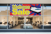 Mattress Sale vinyl banner 8 feet wide hung on the exterior of a furniture and mattress retail store with customers browsing mattress displays inside