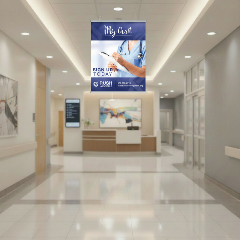 Healthcare patient portal poster displayed in a 28 in aluminum snap-frame sign holder hanging near the ceiling of a hospital lobby