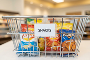 Covered side-loading label holder hanging from its hinged clasp on a chrome wire snack basket.