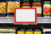 Horizontal 7 by 5.5 inch red starburst shelf sign with blank white message area mounted in a clear holder on a grocery shelf