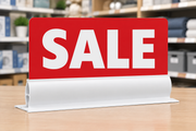 White 12-inch sign foot holder on a retail store table facing front, holding a red and white SALE sign