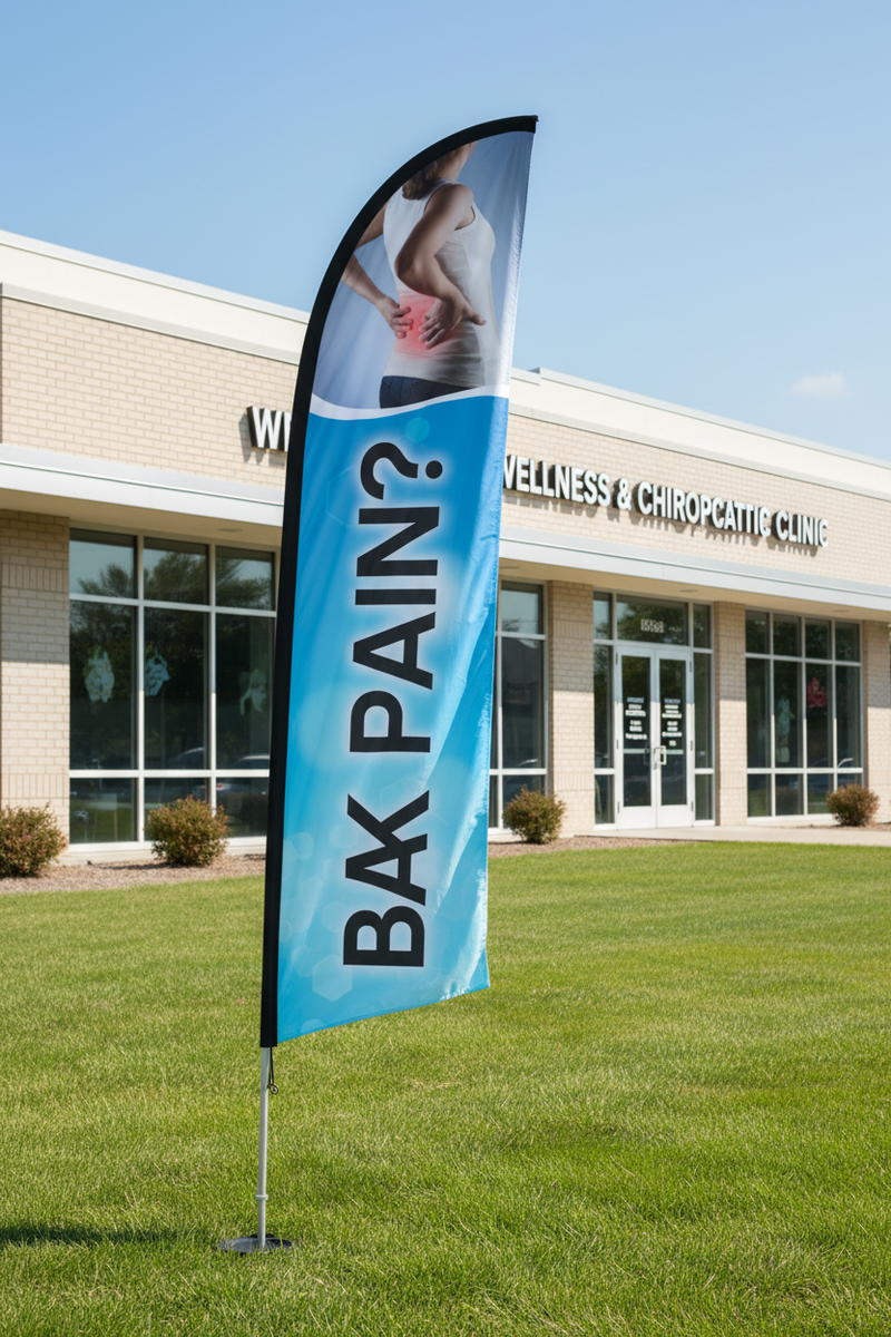 Back Pain feather flag standing on green grass in front of chiropractic office on aluminum pole with ground spike
