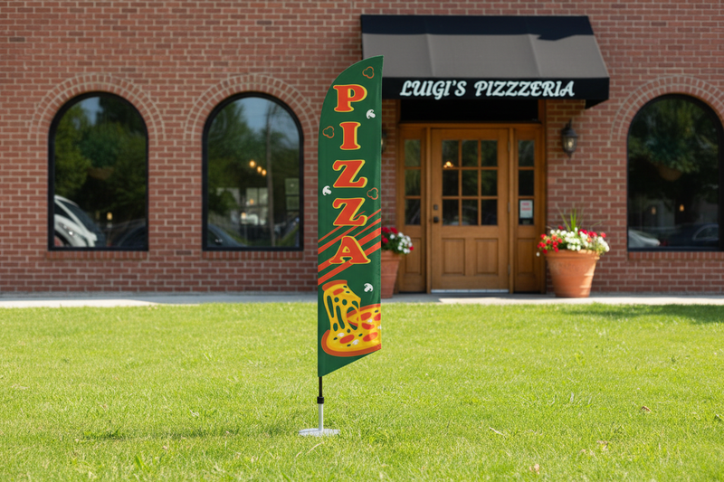 Green Pizza feather flag kit displayed outdoors in grass in front of a pizzeria, 11.5ft flag on aluminum pole with ground spike