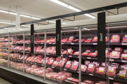 Poultry, Pork, and Beef blade signs mounted with magnetic holders on a supermarket meat case