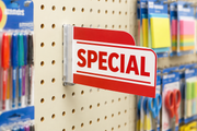 Pegboard sign holder with concealed mounting hooks