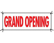 A red and white 'Grand Opening' banner sign with grommets in four corners.