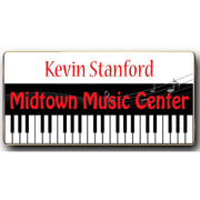 A rectangular metal name badge with a magnetic attachment, featuring the name Kevin Stanford and the Midtown Music Center logo.